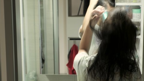 Taipei , Taiwan / Taiwan - 05 16 2019: Woman Blowdries Her Hair