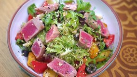 Tuna salad. Serving vegetable salad with tuna in a restaurant. Nisuaz. Food video macro slow motion 