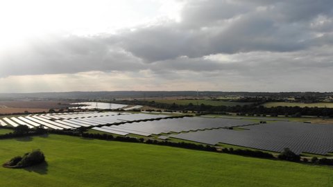 Rotating aerial shot of solar farm on a green field