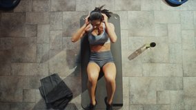 Top View of Professional Female Bodybuilder Doing Bicycle Crunches while Lying on the Yoga Mat in the Hardcore Gym. Muscular and Athletic Beautiful Woman Muscle, Power and Cardio Workout. Zoom Out - Powered by Shutterstock - Get 15% off with code: PIKWIZARD15