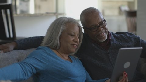 Black couple video chatting on digital tablet