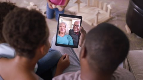 Family video chatting with grandparents