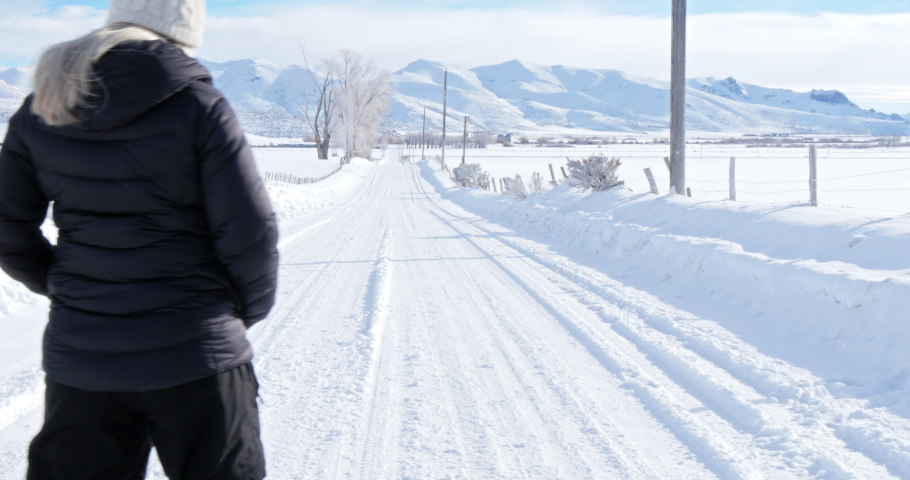 Caucasian couple walking on snowy road