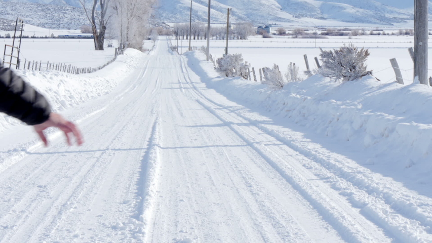 Caucasian couple walking on snowy road