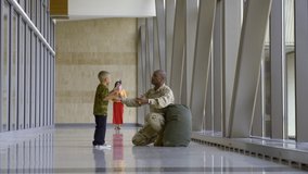 African American soldier greeting family in airport - Powered by Shutterstock - Get 15% off with code: PIKWIZARD15