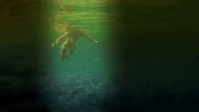 Young woman dives in the sea at night, Night diving in the exotic sea, Video clip