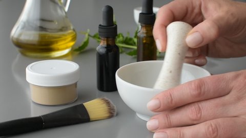 Woman hands mixing in mortar homemade facial mask from natural ingredients