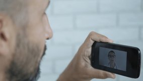 A man goes to the doctor for a video call.