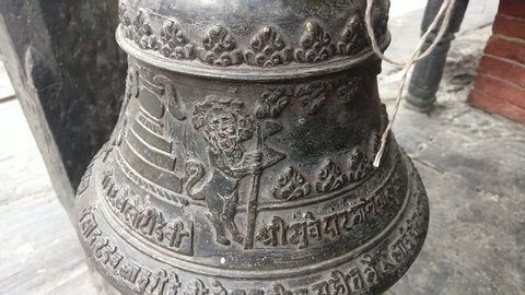 Historical Temple Bell. Lion holding Nepali Flag. Symbolizes that the temple is protected by the lions.