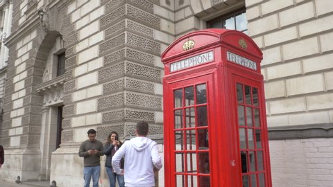 London / United Kingdom (UK) - 05 19 2019: Tourists Take Photos Next To Iconic Red Telephone Box In London, UK. 19 May, 2019