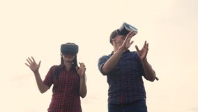 Augmented teamwork future reality device creating virtual space concept slow motion video. lifestyle man and girl in virtual digital glasses the virtual reality. couple using VR-headset
