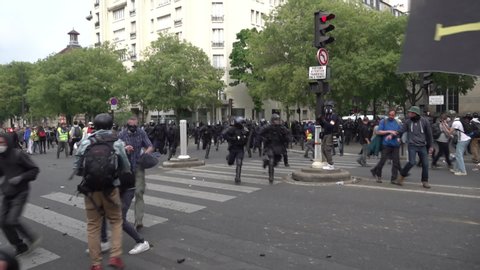 Paris / France - 05 01 2019: Slow motion of a riot police with shields and batons running into make an arrest