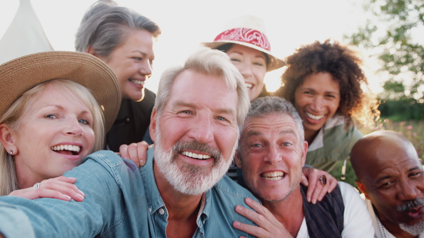POV Shot Of Group Of Mature Friends Posing For Selfie At Outdoor Campsite Royalty-Free Stock Footage #1035278396