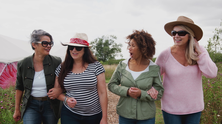 Group Of Mature Female Friends Walking Along Path Through Yurt Campsite | Shutterstock HD Video #1035279023