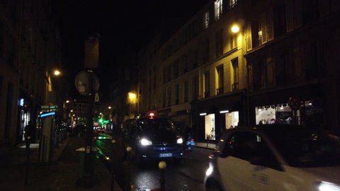 Paris , France / France - 02 15 2019: Busy street gothic building pan in the Le Marais Paris France night 3.