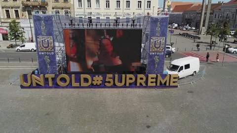 Cluj-Napoca,Cluj/Romania-08.12.2019-A huge screen located in Matei Corvin Square (Mathias Rex) in downtown Cluj-Napoca,runs video footage from the Untold 2019 festival and invites you to register 