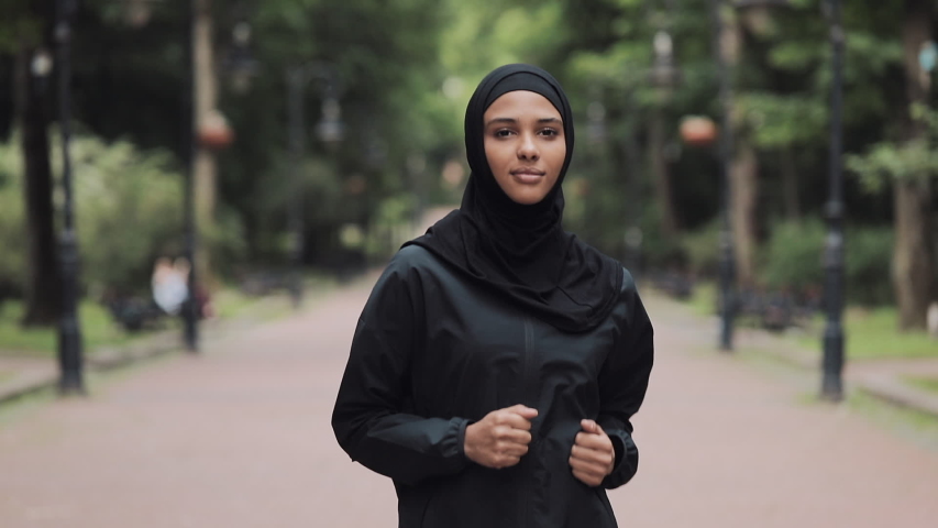 Young Preety Muslin Girl Wearing a Hijabt Running in the Park Concept Healthy Lifestyle. | Shutterstock HD Video #1035285515
