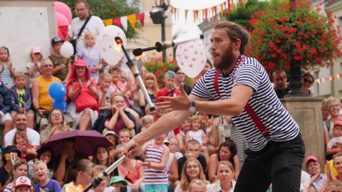 WROCLAW, POLAND - AUG 10, 2019: Circus artist street fireshow performance man entertains adults and children spectators