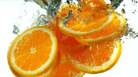 Super Slow Motion Shot of Falling Orange Slices into Water at 1000fps.