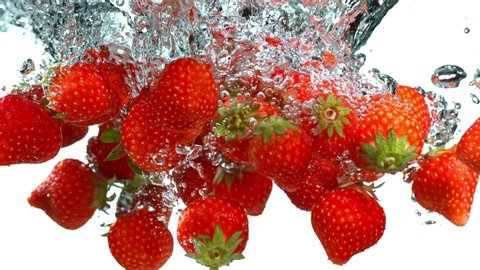 Super Slow Motion Shot of Falling Strawberries into Water at 1000fps.
