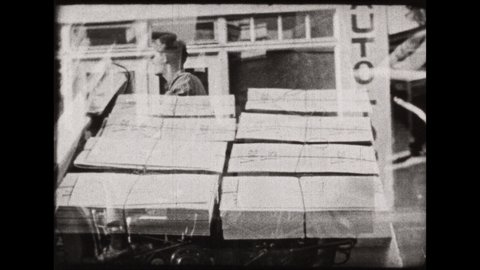 1930s: Papers are stacked in bundles. Man rides motorcycle pulling trailer. Printing press prints newspapers. Kid rides bicycle, throwing newspapers at houses.