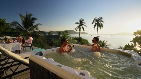 Couples enjoying time in resort ocean view villa with Jacuzzi tub - Phuket Thailand April 2015