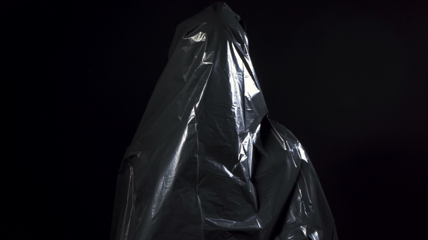 Video of human in black garbage bag