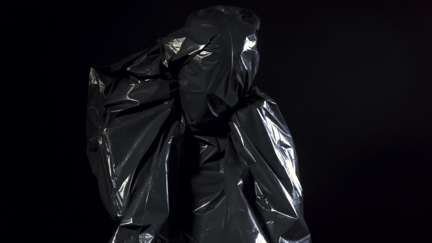 Human in black garbage bag