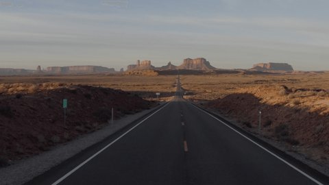 Drone point of view flying above highway road towards Monument valley rock formations in Navajo land in Utah, USA.
Aerial view of famous landmark in western USA