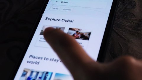 A person looking at hotel rooms in Dubai - Using the Airbnb app on a smartphone - Exploring Dubai city - Abu Dhabi, UAE August 07, 2019