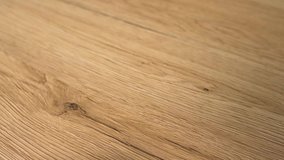 Closeup of the wood floor newly installed. Floor is made of the natural oak hard wood and sanded and finished with natural clear flooring stain. Home improvement and remodel concept in slow motion. - Powered by Shutterstock - Get 15% off with code: PIKWIZARD15