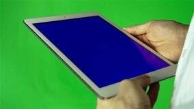 Man Using Tablet Pc With Blue Screen on a Green Screen Background  with Various Hand Gestures (touch, scroll and more).