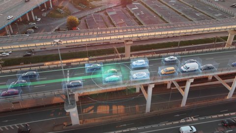 Beautiful aerial presentation of self-driving cars concept on multi-level highway in Moscow. Picturesque aerial panorama of autonomous cars in the road traffic of big city on the evening.