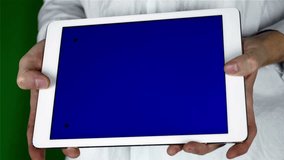 Man Using Tablet Pc With Blue Screen on a Green Screen Background  with Various Hand Gestures (touch, scroll and more).