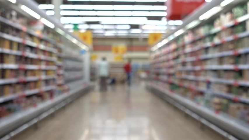 People with shopping carts. People are shopping in a supermarket, defocused blurred background. Royalty-Free Stock Footage #1035370250
