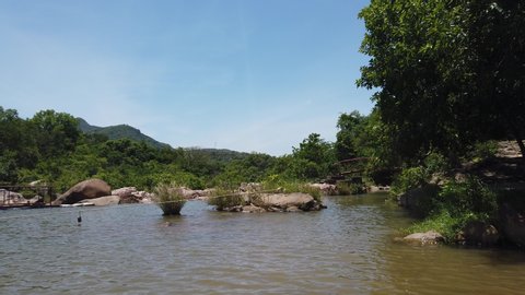 Binh Dinh Province, Viet Nam, June 10th 2019: ecotourism destinations Ham Ho, stream with rock reflect on water surface and blye sky in Binh Dinh, Vietnam