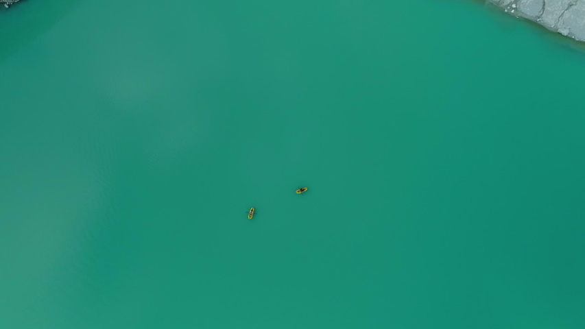 Zoom Out: Two People Kayaking In Light Blue Lake, Surrounded By Rocky Mountains - Mendenhall Glacier, Alaska