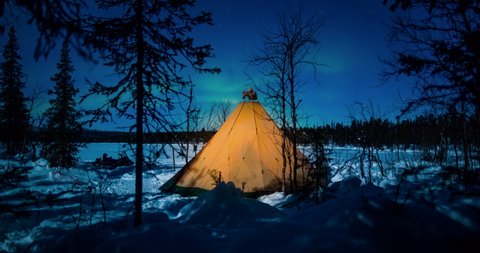 Time Lapse: People Going in and Out of a Lit Up Teepee at Night