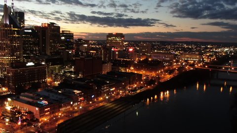 Time Lapse Aerial: Nashville Skyline At Night with Lit Buildings and Bridges over Cumberland