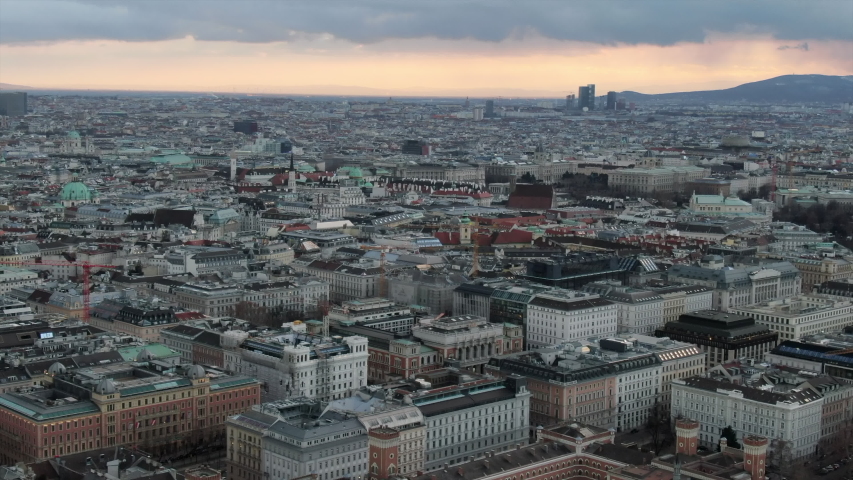 Aerial: Vienna Cityscape with Mountains Behind, in Austria