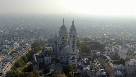 Aerial: Sacre-Cur Church in Paris, France with City Spread Out Beneath