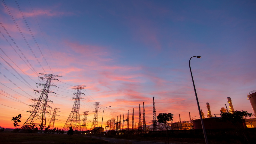 Time lapse: Industrial area, electricity supply substation during colorful sunrise.