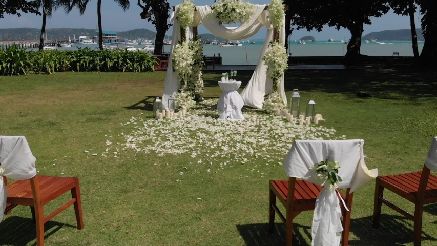 White wedding decorations on a green lawn. guest chairs, sunny day