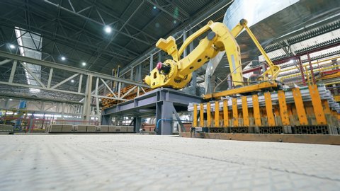Robotic Arm production line. Robot is transporting bricks in batches