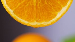 Orange juice dropping from orange slice in slow motion, Close-up fruit for diet and healthy food
