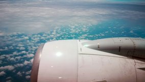 Airplane flight. Wing of an airplane flying above the clouds with cloudy sky. View from the window of the plane. Airplane, Aircraft. Traveling by air. 4K UHD video