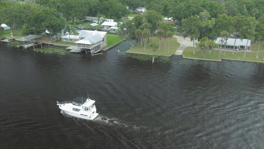 Aerial: Boats and houses along st Johns River. Northern Florida, USA. 22 July 2019