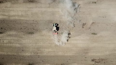 Plowing tractor in a field filmed with drone. Shot in Spain