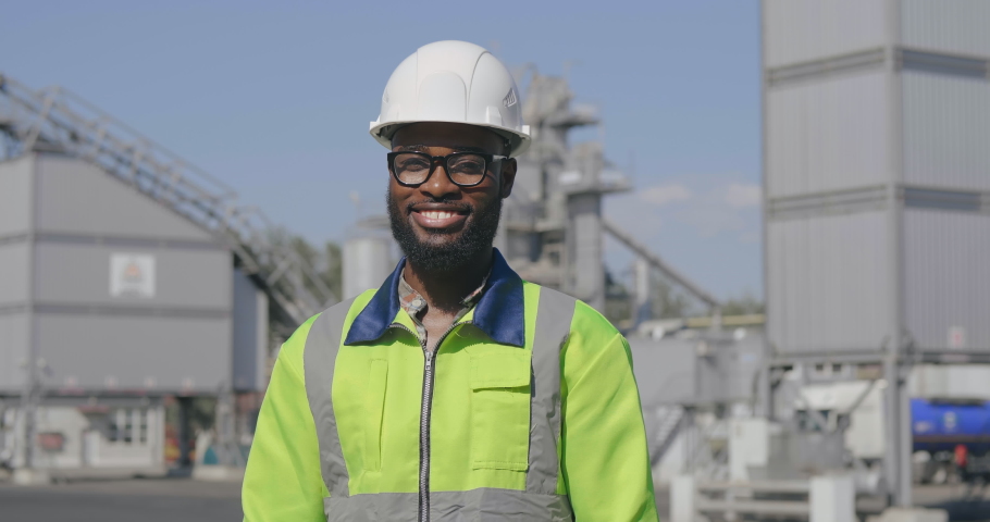 Portrait of young smiling african mine worker with arms folded at mining site Royalty-Free Stock Footage #1035420461