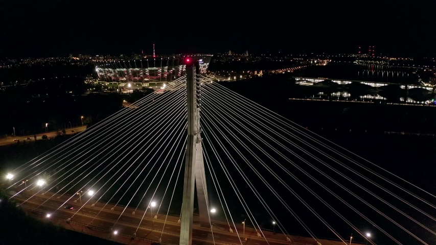 Aerial view of Mozdukha at night bridge and stadium in Warsaw. Poland. Drone shot on night bridge and stadium with beautiful lighting. 4K Shot.